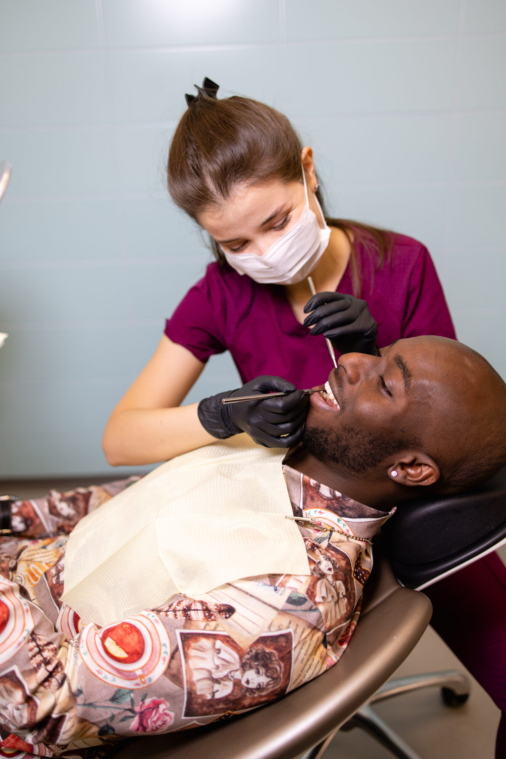 Doctor treats patient teeth in modern dental clinic dentist using UV light on a patient's teeth